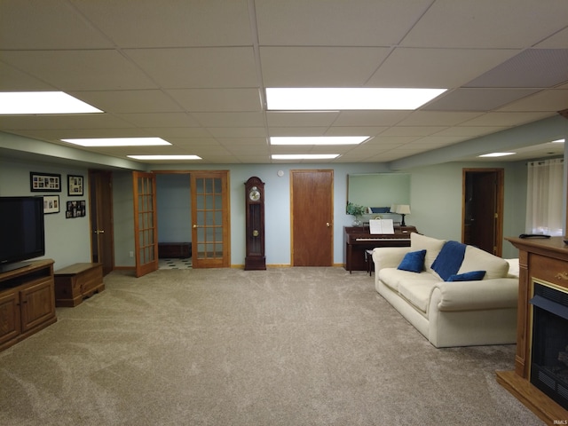 carpeted living room with a paneled ceiling