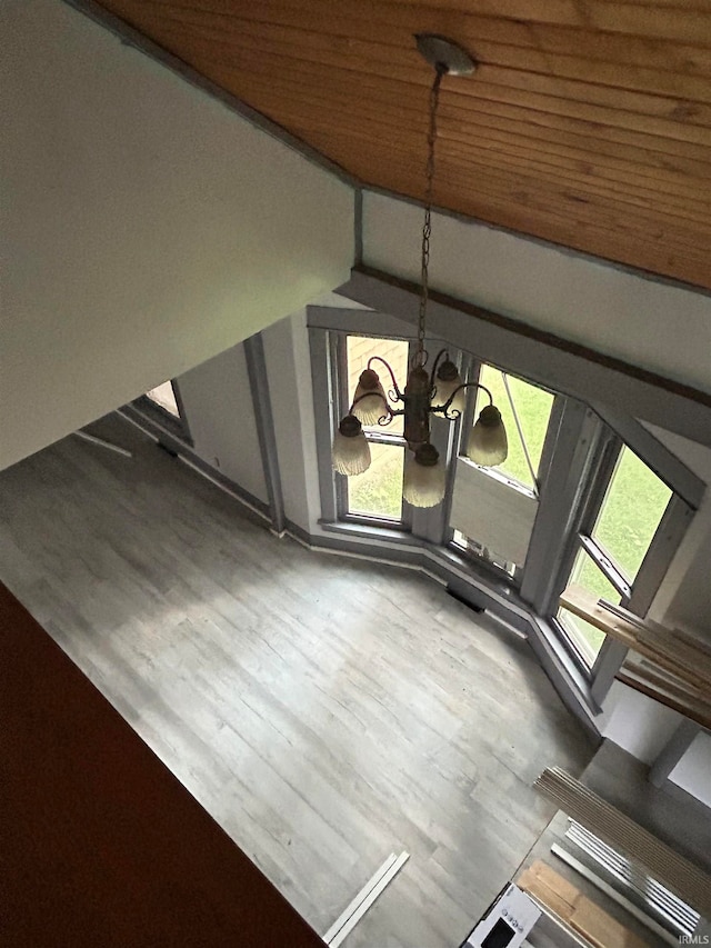 interior details featuring a chandelier, hardwood / wood-style flooring, and wooden ceiling