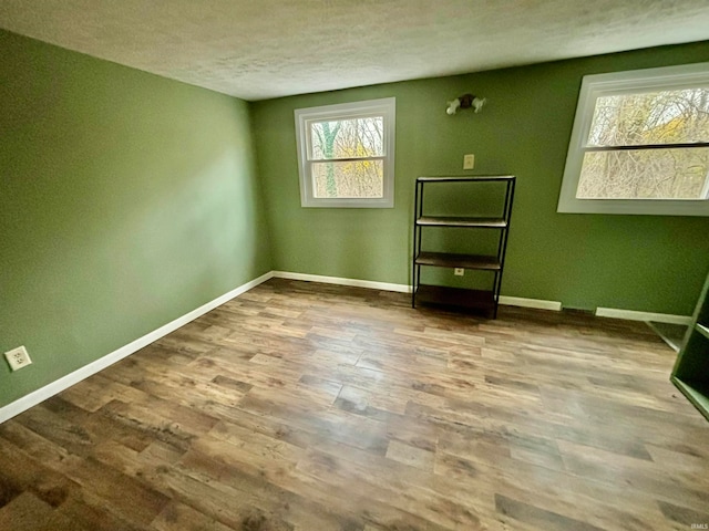 unfurnished room with hardwood / wood-style floors