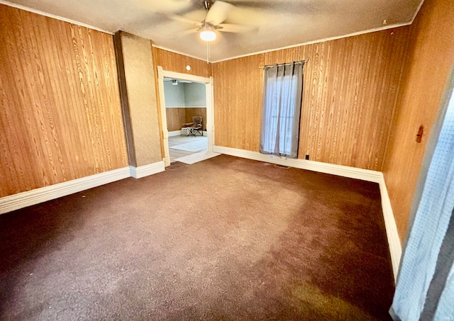 unfurnished bedroom featuring wooden walls, crown molding, and ceiling fan