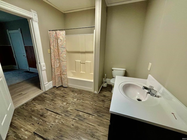 full bathroom with toilet, wood-type flooring, vanity, and shower / tub combo with curtain