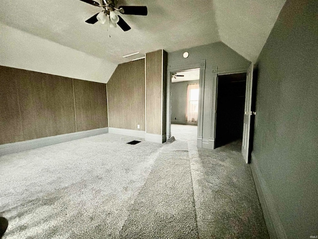 bonus room featuring a textured ceiling, light colored carpet, ceiling fan, and lofted ceiling