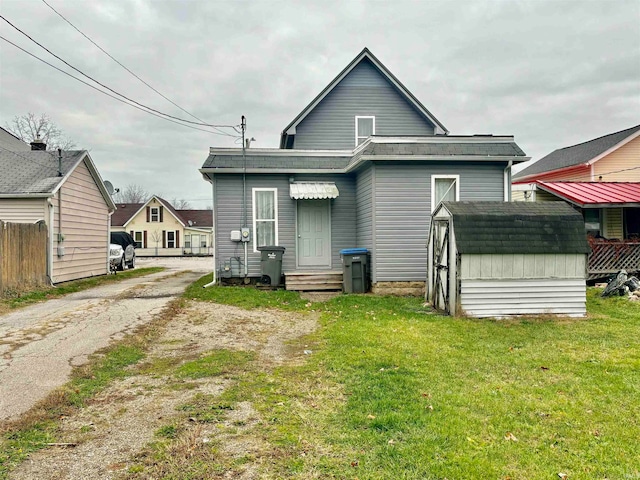 rear view of house featuring a yard