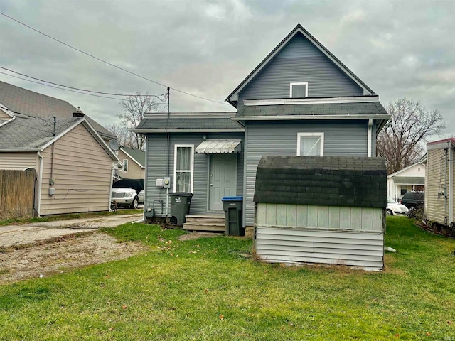 rear view of property with a lawn