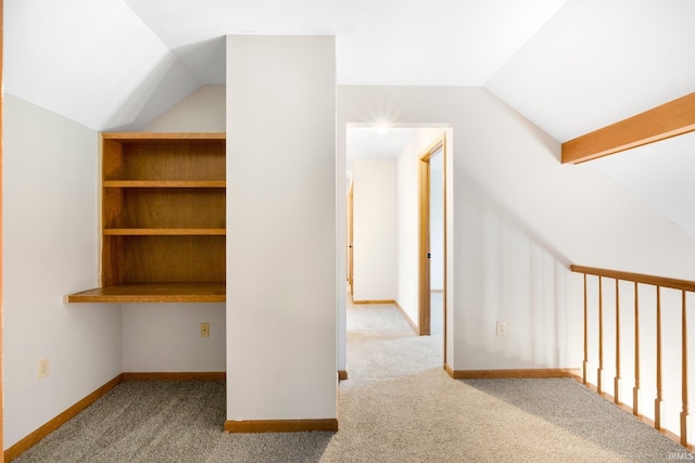 additional living space with light colored carpet and lofted ceiling