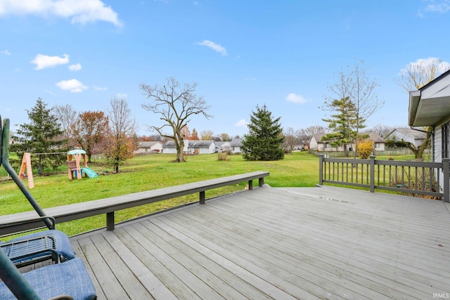 wooden deck featuring a lawn and a playground