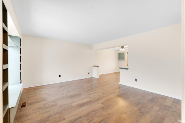 empty room featuring ceiling fan and light hardwood / wood-style flooring