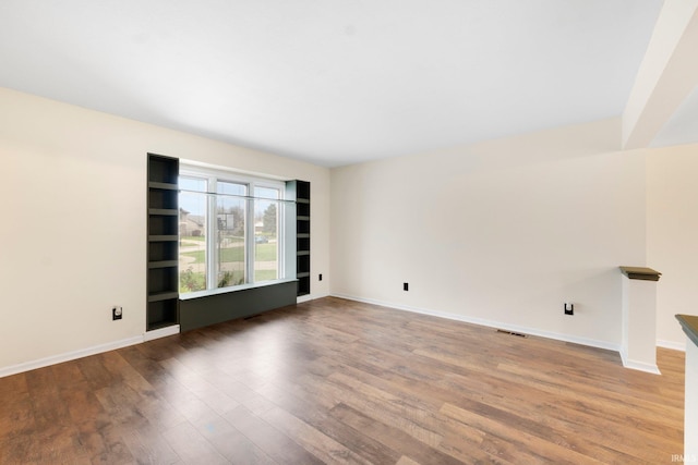 unfurnished room with hardwood / wood-style floors