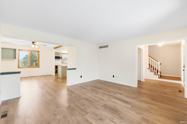 unfurnished living room featuring light hardwood / wood-style floors and ceiling fan