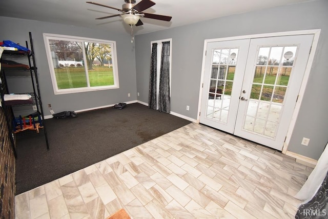 doorway to outside featuring french doors, light colored carpet, a wealth of natural light, and ceiling fan