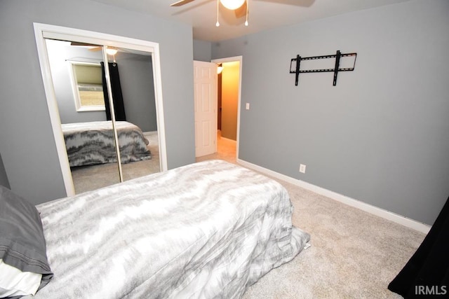 carpeted bedroom featuring ceiling fan and a closet