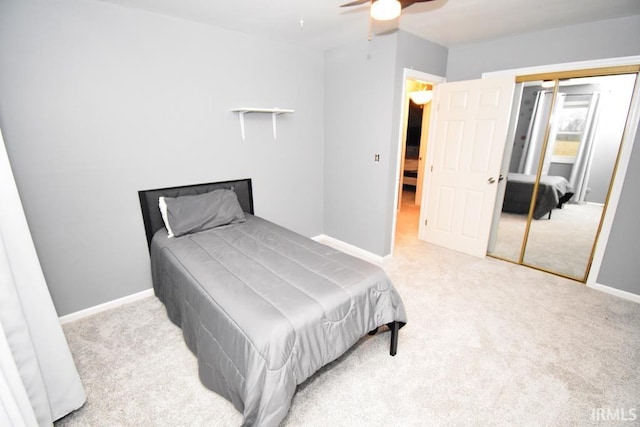 bedroom with ceiling fan, a closet, and light carpet