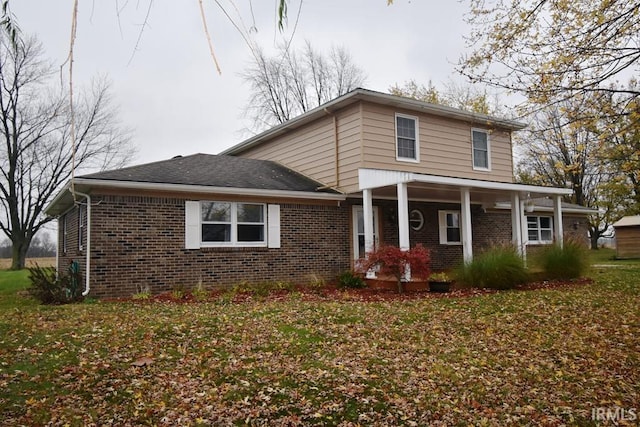 view of front of property with covered porch and a front yard