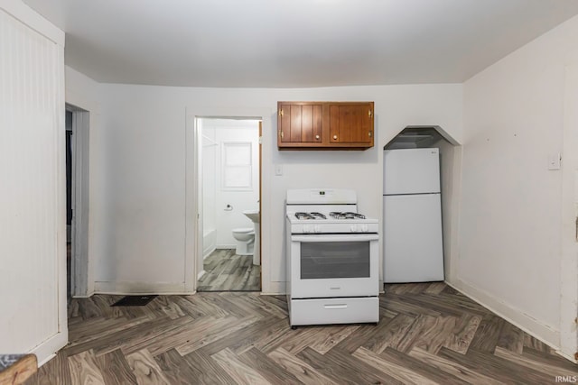 kitchen with dark parquet floors and white appliances