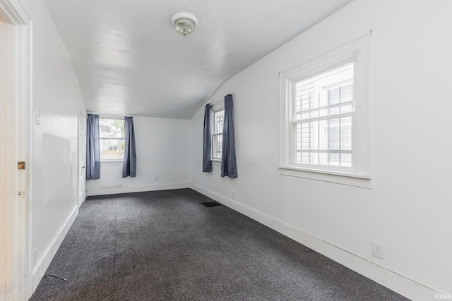 unfurnished room with carpet and lofted ceiling