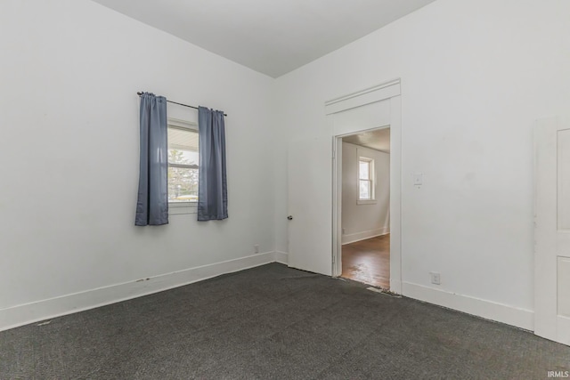 carpeted empty room featuring plenty of natural light