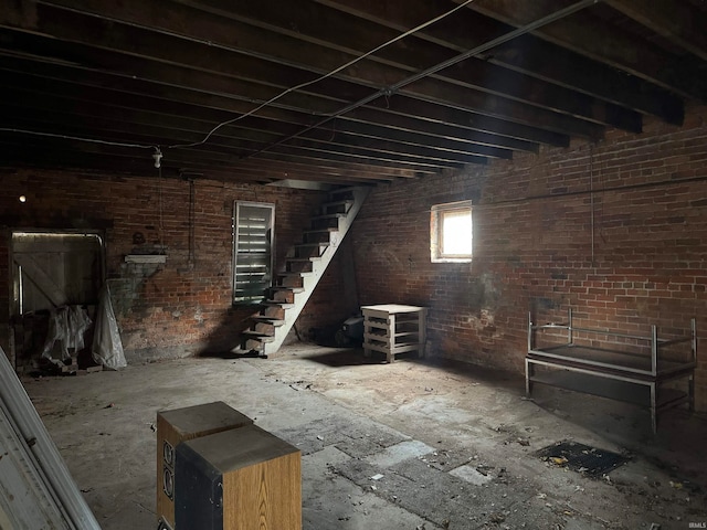 basement featuring brick wall