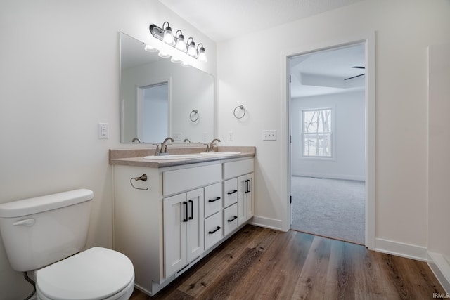 bathroom featuring hardwood / wood-style flooring, vanity, and toilet