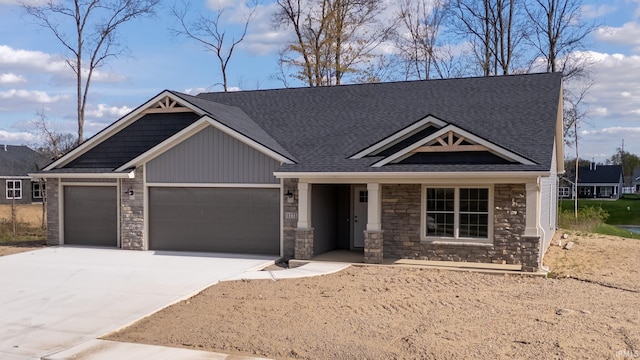 1173 Olympiada Knl, Fort Wayne, IN 46845 - craftsman-style home featuring stone siding, an attached garage, concrete driveway, board and batten siding, and roof with shingles