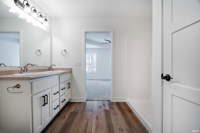 bathroom with vanity, ceiling fan, and wood-type flooring