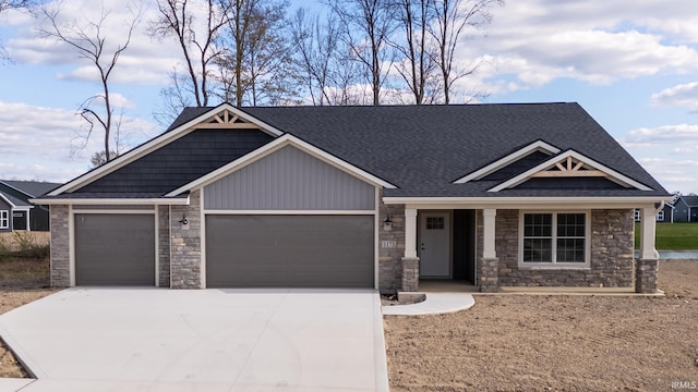 1173 Olympiada Knl, Fort Wayne, IN 46845 - craftsman inspired home featuring an attached garage, stone siding, driveway, and a shingled roof