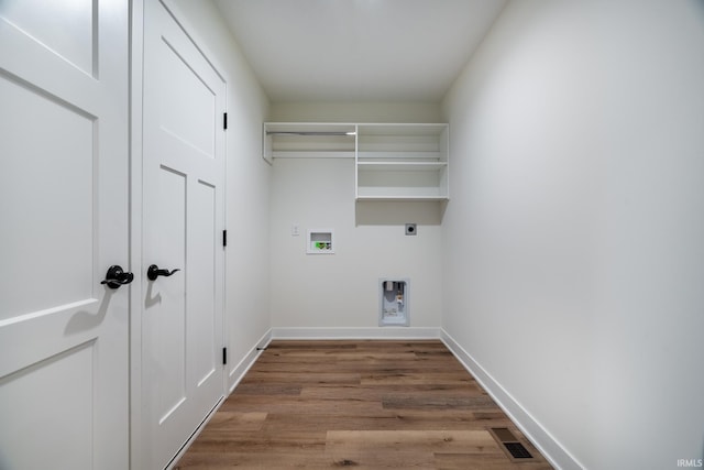 clothes washing area featuring hookup for a washing machine, light wood-type flooring, and electric dryer hookup