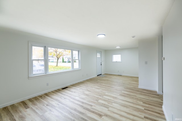 unfurnished room with a wealth of natural light and light hardwood / wood-style floors