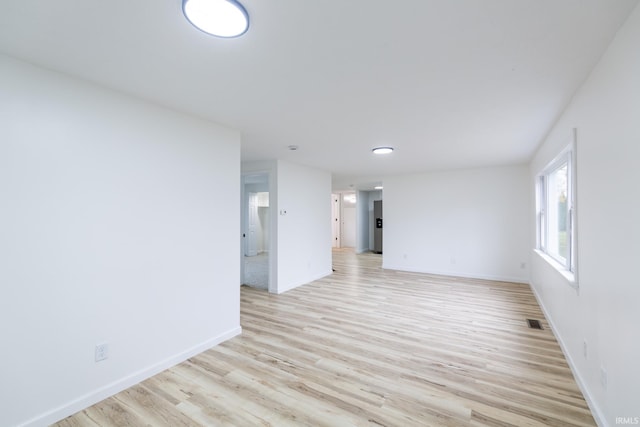 spare room with light hardwood / wood-style flooring