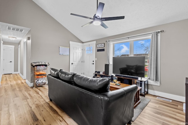 living room with ceiling fan, high vaulted ceiling, light hardwood / wood-style floors, and a textured ceiling