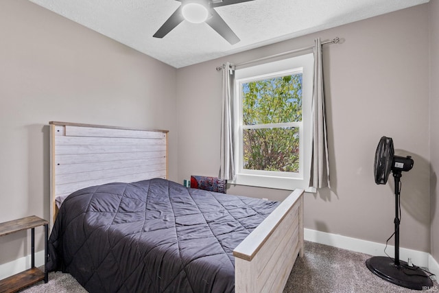 carpeted bedroom featuring ceiling fan and a textured ceiling