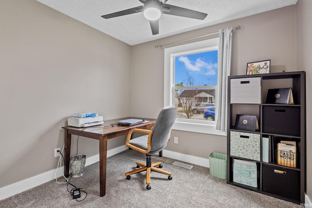 carpeted office with ceiling fan and a textured ceiling