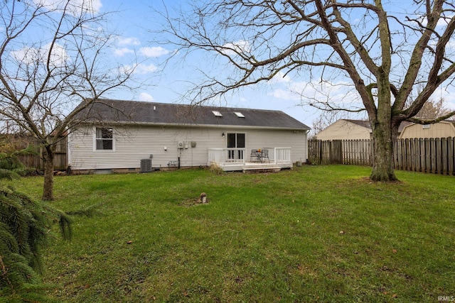 back of house with a yard, a deck, and central air condition unit