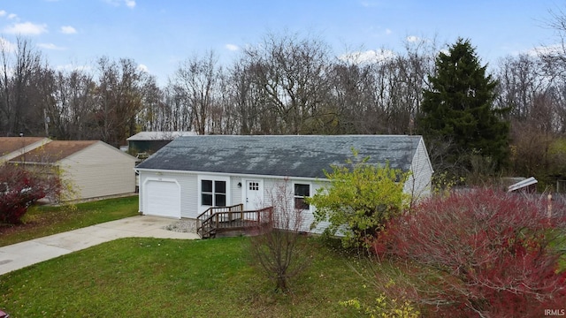 back of house with a lawn and a garage