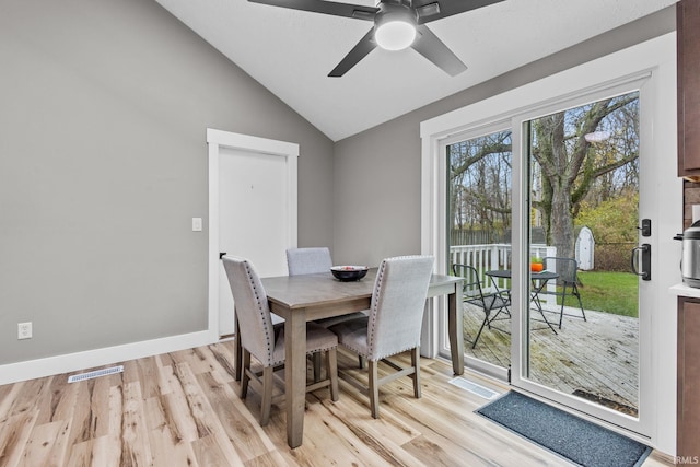 dining space with light wood-type flooring, ceiling fan, and lofted ceiling