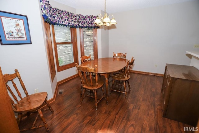 dining space with a chandelier and dark hardwood / wood-style floors