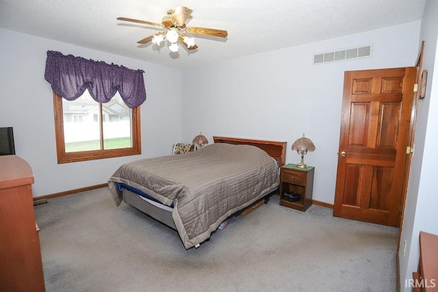 bedroom featuring ceiling fan and light carpet