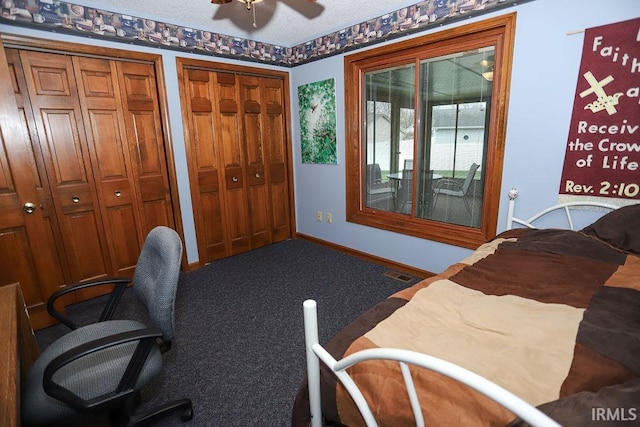 bedroom featuring ceiling fan, carpet floors, a textured ceiling, and two closets