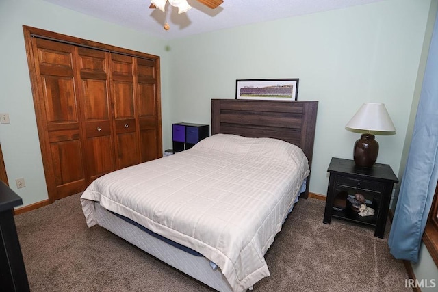 carpeted bedroom featuring ceiling fan and a closet