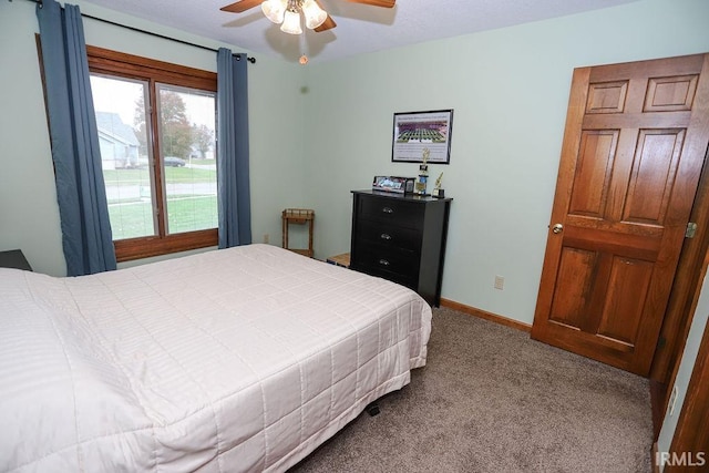 carpeted bedroom with ceiling fan