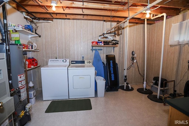 laundry room with gas water heater and separate washer and dryer