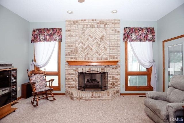 carpeted living room with a fireplace