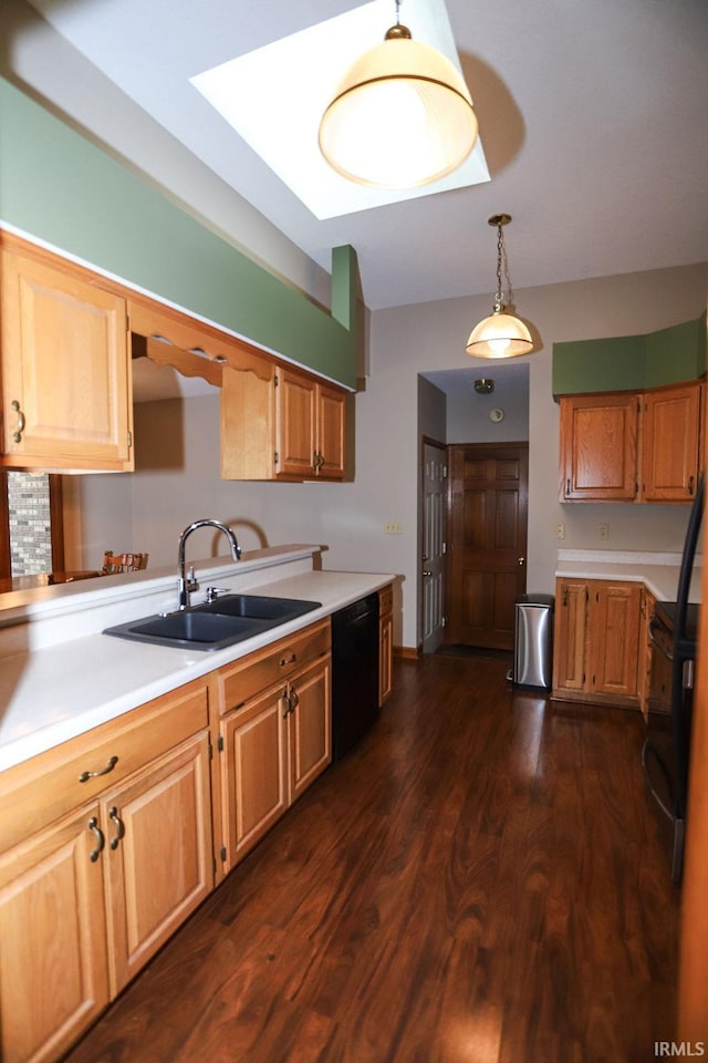 kitchen featuring pendant lighting, dark hardwood / wood-style flooring, black appliances, and sink