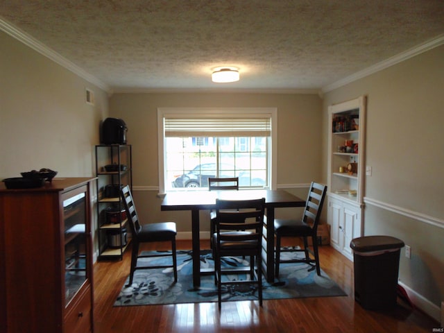 dining space with crown molding, hardwood / wood-style floors, and a textured ceiling