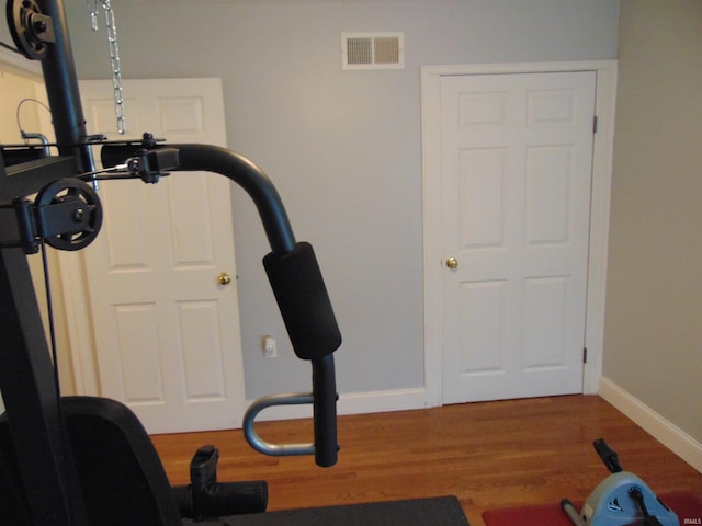 workout area with hardwood / wood-style floors