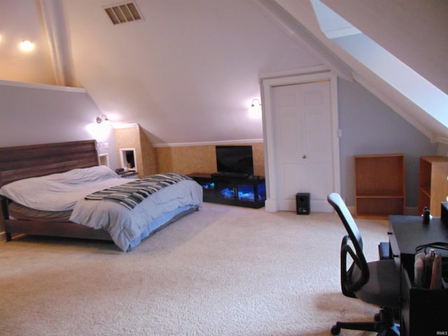 carpeted bedroom with vaulted ceiling with skylight