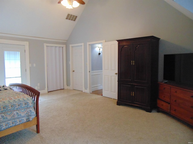 carpeted bedroom featuring ceiling fan and high vaulted ceiling