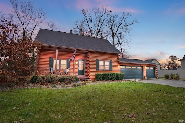 log cabin with a yard and a garage