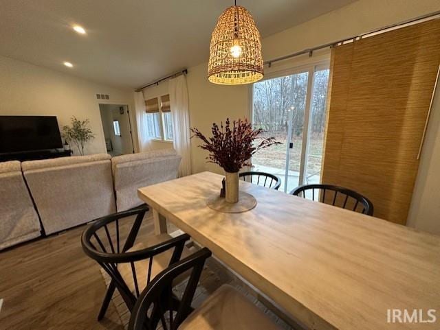 dining space with wood-type flooring