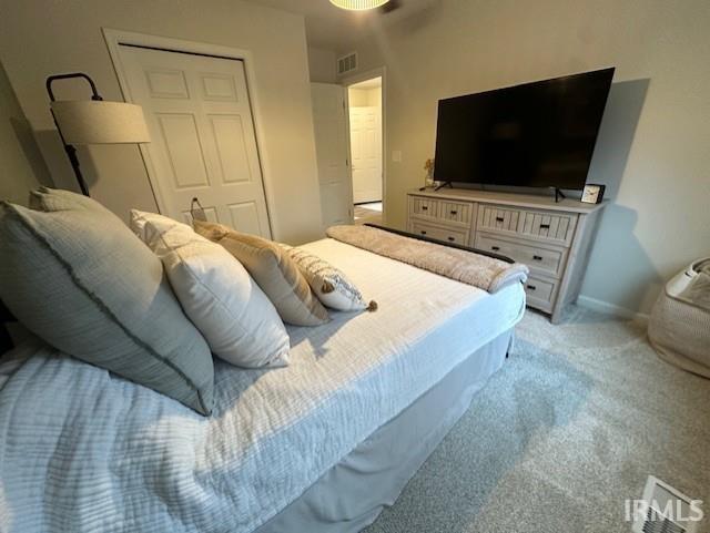 carpeted bedroom with a closet