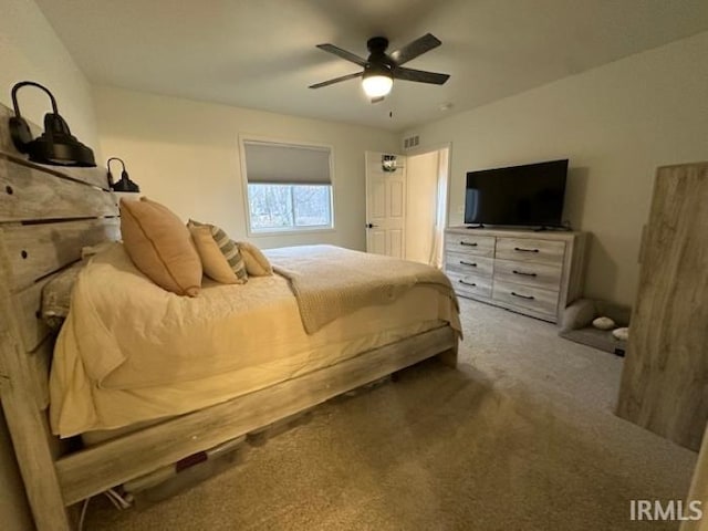 bedroom with dark colored carpet and ceiling fan